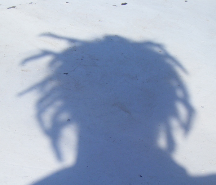 The shadow from my dreadlocks on the foredeck of the felucca.