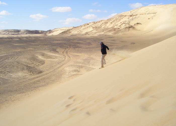 Running down a dune in the western dessert.