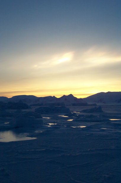 A nacreous or polar stratospheric cloud over the winter sea ice. The chemical reaction that destroys atmospheric ozone takes place on the surface of these clouds and so their increasing number in the Antarctic Spring is important to observe.