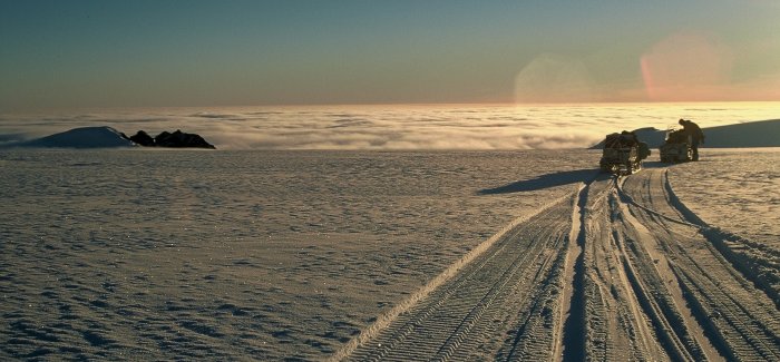 A skidoo and sledge overlooking the cloud covering Carvajal and the north-eastern tip of Adelaide Island.