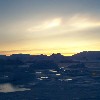A nacreous or polar stratospheric cloud over the winter sea ice. The chemical reaction that destroys atmospheric ozone takes place on the surface of these clouds and so their increasing number in the Antarctic Spring is important to observe.