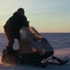 One of the staff driving a skidoo across our cross-country course on the last day the sun was above the horizon during the winter.
